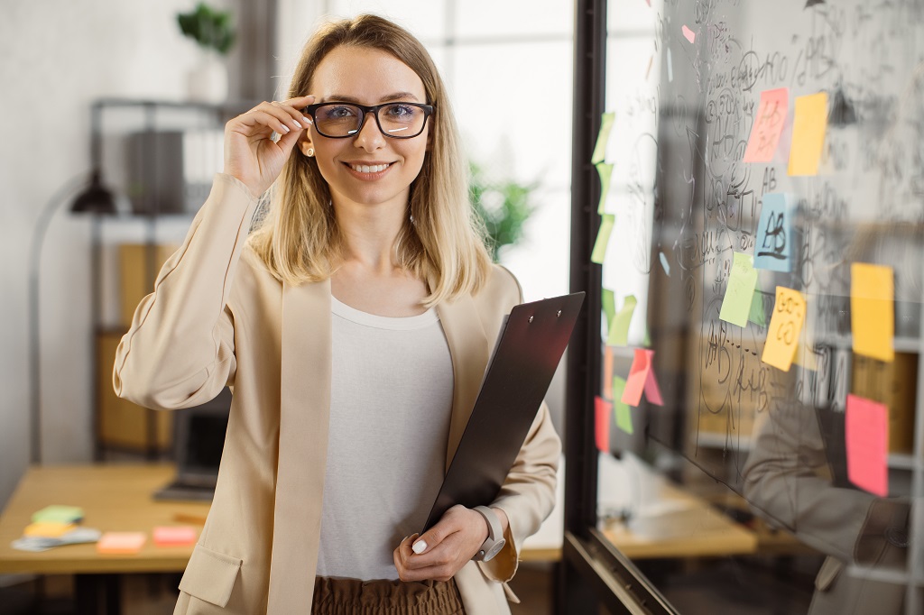 business lady holding clipboard and smiling