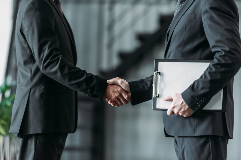 two businessmen shaking hands as a sign of a closed deal