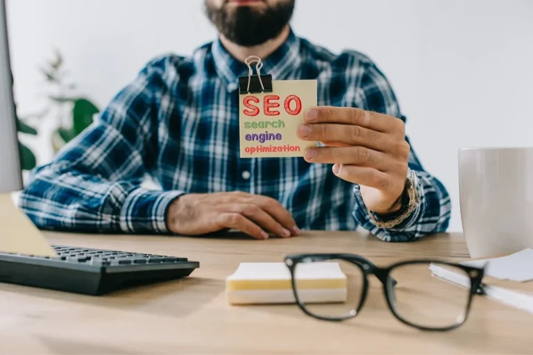 professional holding a paper with search engine optimization written on it